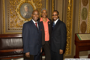 ["Three unidentified individuals stand outside the Senate."]%