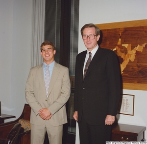 ["Senator John D. (Jay) Rockefeller stands next to an unidentified young man in his office."]%