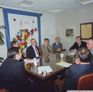 ["Senator John D. (Jay) Rockefeller sits at a conference table with several unidentified men during a Kammer Tall Stacks meeting."]%