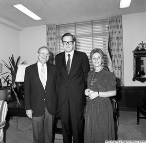 ["Senator John D. (Jay) Rockefeller stands for a photograph with two unidentified individuals in his Washington office."]%