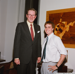 ["Senator John D. (Jay) Rockefeller stands next to one of his interns."]%