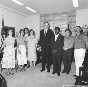 ["Senator John D. (Jay) Rockefeller stands in his office for a photograph with an unidentified group."]%