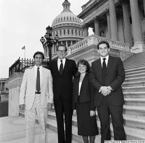 ["Senator John D. (Jay) Rockefeller and three unidentified individuals pose for a photograph on the steps of the U.S. Capitol Building."]%