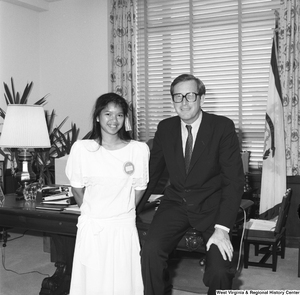 ["Senator John D. (Jay) Rockefeller poses for a photograph with a young unidentified girl in his Washington office."]%