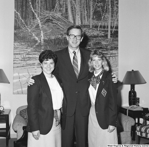 ["Senator John D. (Jay) Rockefeller stands for a photograph with two members of the Distributive Education Clubs of America (DECA). DECA is an international association of high school and college students that prepares leaders in marketing, entrepreneurship, and management."]%