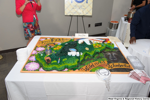 ["A large birthday cake celebrates the 150th anniversary of West Virginia's statehood."]%