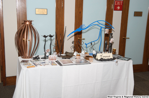 ["Artwork from Tamarack is displayed at the 150th birthday celebration for West Virginia."]%