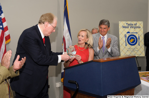 ["Senator John D. (Jay) Rockefeller receives an award during the 150th birthday celebration for West Virginia."]%