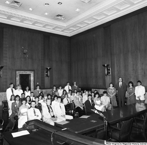 ["Senator John D. (Jay) Rockefeller stands next to a large group of West Virginia students in a Senate building."]%