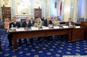 ["Six individuals sit and testify before the Senate Commerce Committee."]%