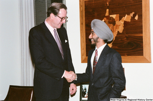 ["Senator John D. (Jay) Rockefeller shakes hands with an intern."]%