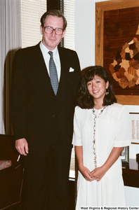 ["Senator John D. (Jay) Rockefeller stands next to a young woman in his office."]%
