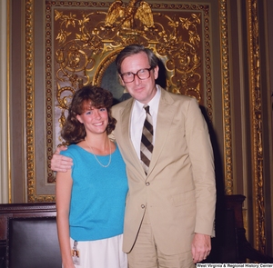["Senator John D. (Jay) Rockefeller poses for a photograph with an unidentified woman in the President's Office outside the Senate."]%