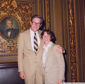 ["Senator John D. (Jay) Rockefeller poses for a photograph with an unidentified woman in the President's Office outside the Senate."]%