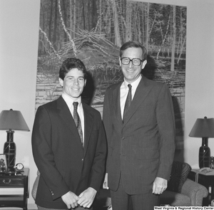 ["Senator John D. (Jay) Rockefeller smiles next to an unidentified man in his office."]%