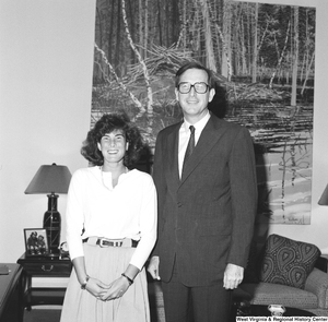 ["Senator John D. (Jay) Rockefeller stands next to an unidentified young woman in his office."]%