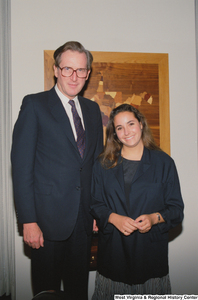 ["Senator John D. (Jay) Rockefeller stands next to a young woman who is possibly an intern."]%