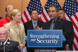 ["An unidentified man speaks at a Strengthening our Security press event."]%