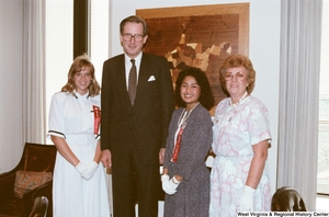 ["Senator John D. (Jay) Rockefeller stands with the two West Virginia participants in Girls Nation."]%