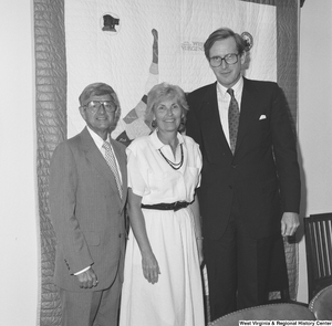 ["Senator John D. (Jay) Rockefeller stands next to two unidentified individuals in his office."]%