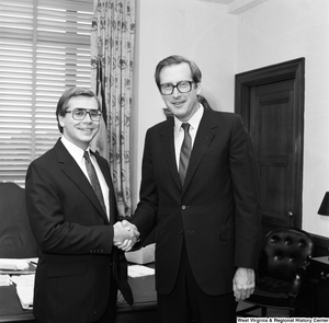 ["Senator John D. (Jay) Rockefeller and an unidentified guest shake hands in his Washington office."]%
