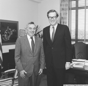 ["Senator Rockefeller stands for a photograph with an unidentified man in his office."]%