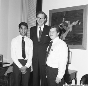 ["Senator John D. (Jay) Rockefeller stands with two Senate Democratic Pages in his office."]%