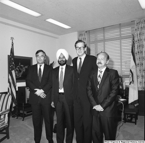 ["Senator John D. (Jay) Rockefeller stands with three unidentified guests for a photograph in his Washington office."]%