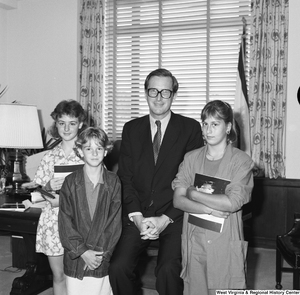 ["Three unidentified students stand for a photograph with Senator John D. (Jay) Rockefeller in his Washington office."]%