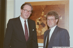 ["Senator John D. (Jay) Rockefeller stands next to an unidentified man in his office."]%