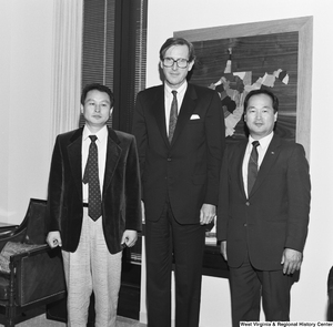 ["Senator John D. (Jay) Rockefeller stands in his office with two unidentified individuals."]%