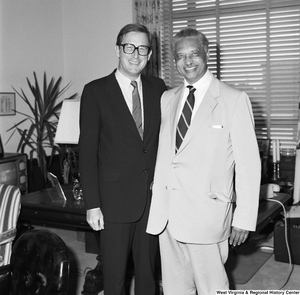 ["Senator John D. (Jay) Rockefeller stands for a photograph with an unidentified individual."]%