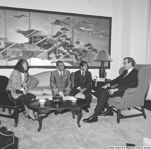 ["Senator John D. (Jay) Rockefeller sits in his office and speaks with three unidentified Japanese representatives."]%
