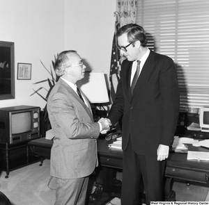 ["Senator John D. (Jay) Rockefeller shakes hands with an unidentified guest in his Washington office."]%