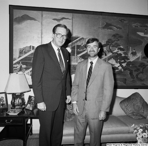 ["Senator John D. (Jay) Rockefeller stands with an unidentified man in his office."]%