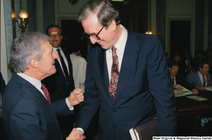 ["Senator John D. (Jay) Rockefeller shakes hands with a man before a hearing."]%
