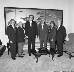 ["Senator John D. (Jay) Rockefeller stands with a group of unidentified men in his Washington office."]%