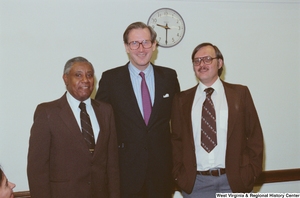 ["Senator John D. (Jay) Rockefeller stands between two unidentified men after a long-term healthcare hearing."]%