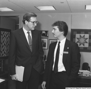 ["Senator John D. (Jay) Rockefeller stands next to a Senate Democratic Page in his office."]%
