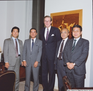 ["Senator John D. (Jay) Rockefeller stands with four members of a Japanese delegation in his office."]%