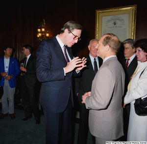 ["Senator John D. (Jay) Rockefeller speaks to a man during an event in the Senate."]%