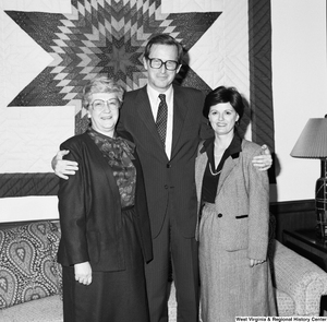 ["Senator John D. (Jay) Rockefeller stands for a photograph with two unidentified women."]%