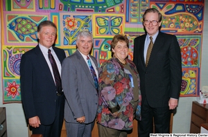 ["Senator John D. (Jay) Rockefeller stands with three guests in front of the colorful quilt in his office."]%