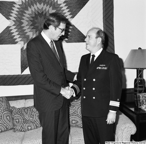 ["Senator John D. (Jay) Rockefeller shakes the hand of Commander Butcher of the Navy in his Washington office."]%
