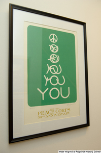 ["A 50th anniversary poster for the Peace Corps hangs on a wall in Senator John D. (Jay) Rockefeller's office."]%