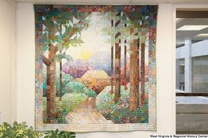 ["A quilt showing trees and mountains hangs in Senator John D. (Jay) Rockefeller's office."]%