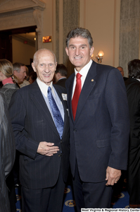 ["Senator Joe Manchin stands with an unidentified man after his swearing-in ceremony."]%