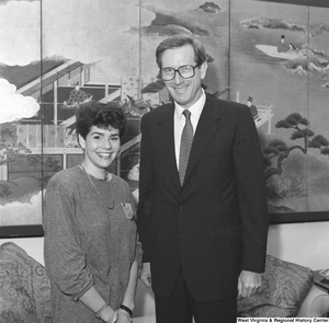 ["Senator John D. (Jay) Rockefeller stands next to a participant in the National Young Leaders Conference in front of the couch in his office."]%