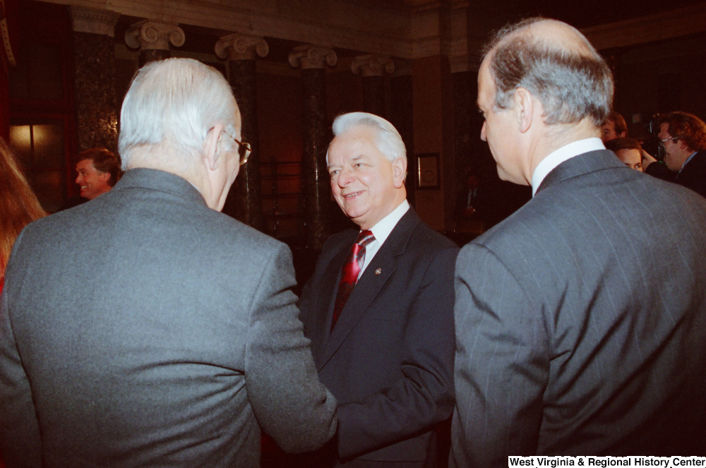 ["Senator Robert C. Byrd speaks with two unidentified men after Senator John D. (Jay) Rockefeller's second Senate Swearing-In Ceremony."]%