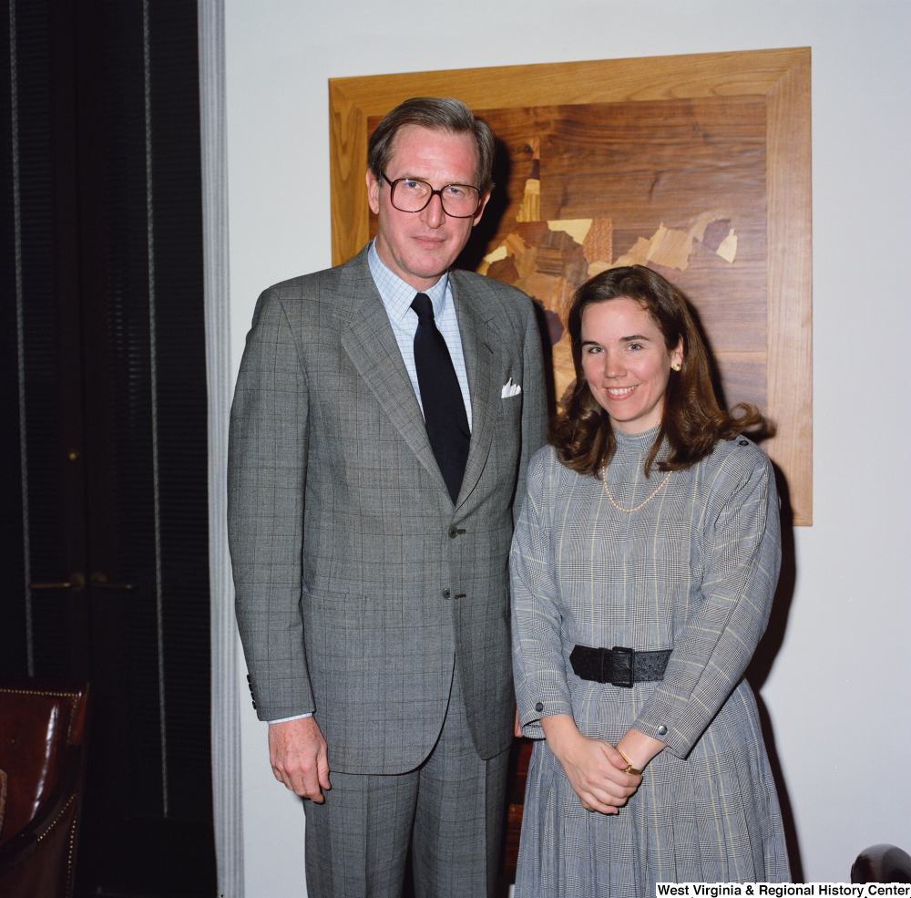 ["Senator John D. (Jay) Rockefeller stands next to a young woman in his office."]%